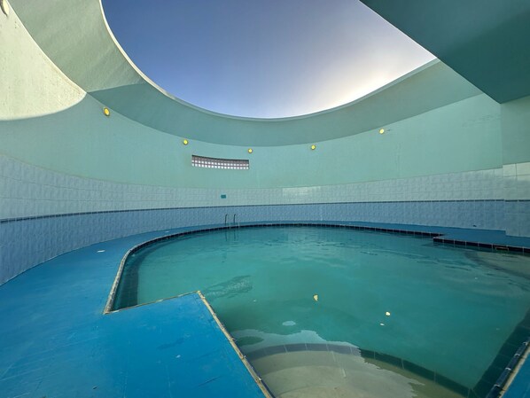 Swimmers can enjoy a unique pool experience within a semi-enclosed space.