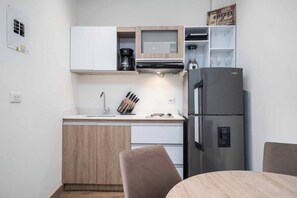 Enjoy cooking and dining in this well-equipped kitchen with a microwave, coffee maker, and refrigerator.