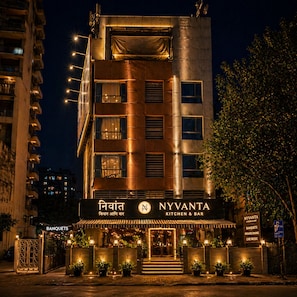 A building with a sign for 'NYVANTA KITCHEN & BAR' and a 'BANQUETS' sign below.