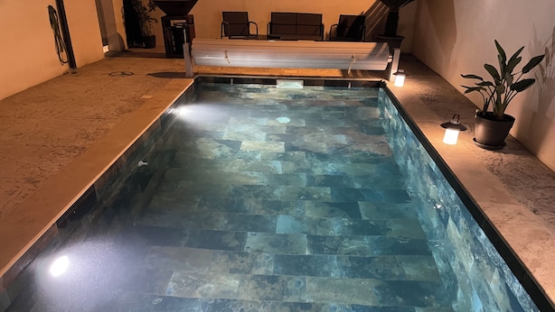 A rectangular indoor pool with a stone-tiled bottom and a clear water surface. - Superb villa with pool 10 minutes from the beach (Sérignan)