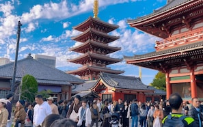 Explore a traditional Japanese temple with a striking multi-tiered pagoda and classic architectural details.
