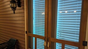 A wooden door with glass panels and a metal handle. - Haffa's Unrivaled Expeditions At Lake Murray Palmetto Retreat (Gilbert)