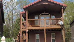 A two-story wooden house with a balcony, a satellite dish, and a mailbox. - Haffa's Unrivaled Expeditions At Lake Murray Palmetto Retreat (Gilbert)