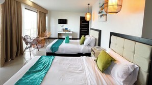 A hotel room with two beds, a desk, a chair, a TV, and a painting on the wall. - Sacaan Tropical Breeze Resort (Sogod)
