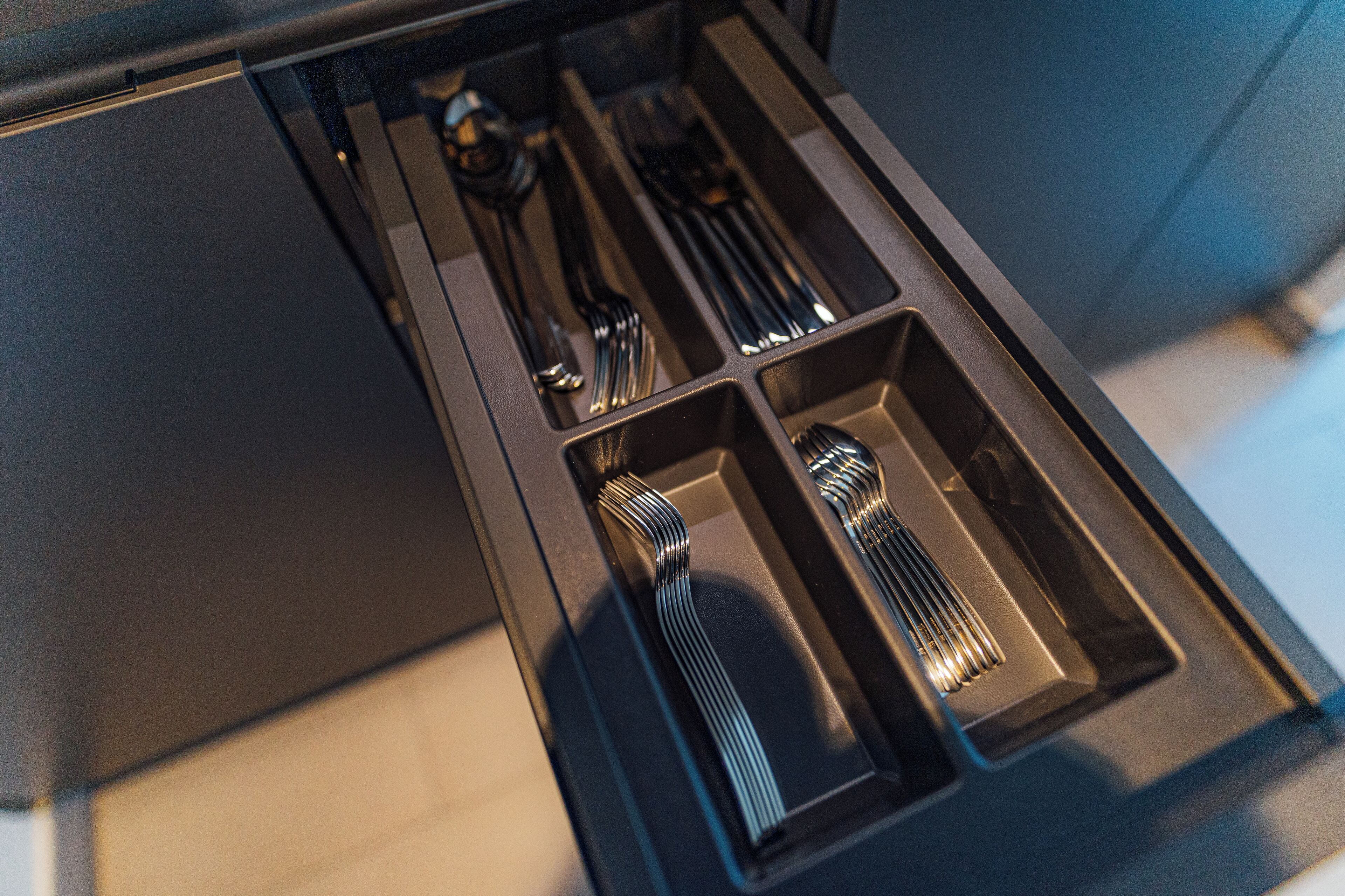 A drawer with utensils.