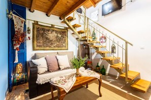 Relax in this inviting living room with a sofa set, coffee table, and wall decorations.