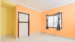 A room with a door, a window with curtains, and a tiled floor. - DETEEX AVINABA INN (Barasat)