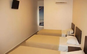 A hotel room with two single beds, a small TV on the wall, and an air conditioning unit above the beds. - OYO 91119 Hotel D Lima Inn (Langkawi)