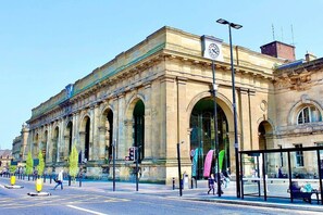 A historic building with large arched windows and a clock tower.