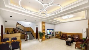A spacious living area with a modern staircase, a dining area, and a TV mounted on the wall. - Anji Qile Farm (Anji)