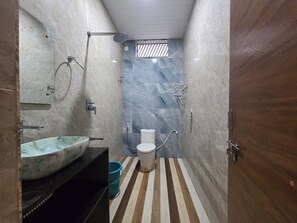 Standard Double Room, Patio, Garden View | Bathroom | Shower, towels, soap, shampoo - Lakshmi Villa (Hospet)