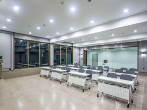 A conference room with white tables and chairs, large windows, and a glass partition wall. - Mercure Qingdao Zhanqiao (Qingdao)