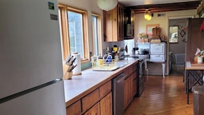 A kitchen with wooden cabinets, a stainless steel refrigerator, and a wooden countertop. - Red Fox Ridge Cabin Retreat - No Cleaning Fee. Relax and unwind (Butler)