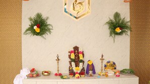 A shrine with a central idol, surrounded by offerings and decorations. - UJ PALLAZZIO - Business Class Luxury Hotel (Tiruvannamalai)