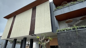 A modern building with a flat roof, large windows, and a flat facade. - Keenan Living Luxe Seturan (Depok)