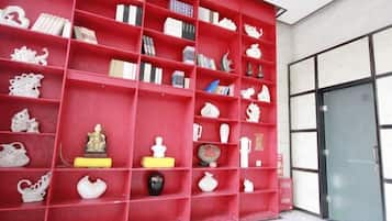 A red shelving unit with various decorative items.