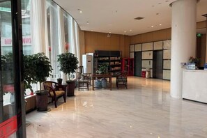 A spacious lobby with a reception desk, seating area, and large windows. - Mingjun Fashion Hotel (Shangqiu)
