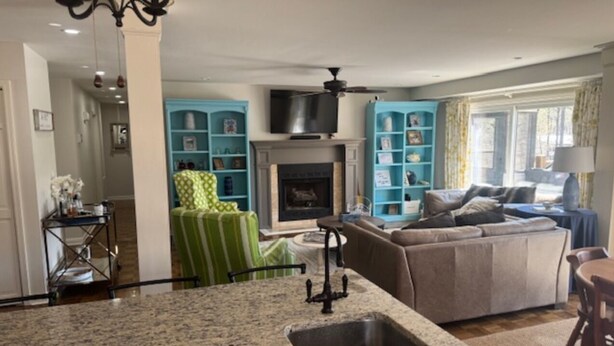 A modern kitchen with granite countertops and a built-in sink. - 5 Bedroom House (Greensboro)