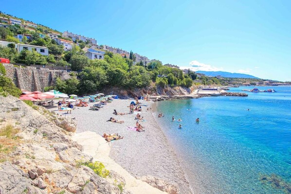 Enjoy a relaxing day at the beach with umbrellas and beach chairs available for your comfort.