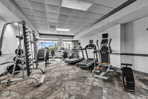 A gym with treadmills, weight machines, and a stationary bike.
