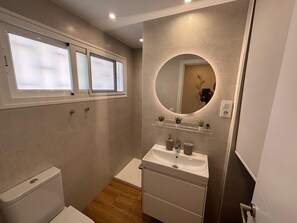 Shower, hair dryer, towels, toilet paper