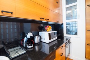 Fridge, microwave, stovetop, coffee/tea maker