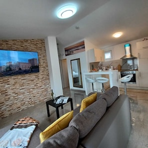 Apartment (Beachfront Apartment with Balcony and) | Living room | 32-inch flat-screen TV with satellite channels