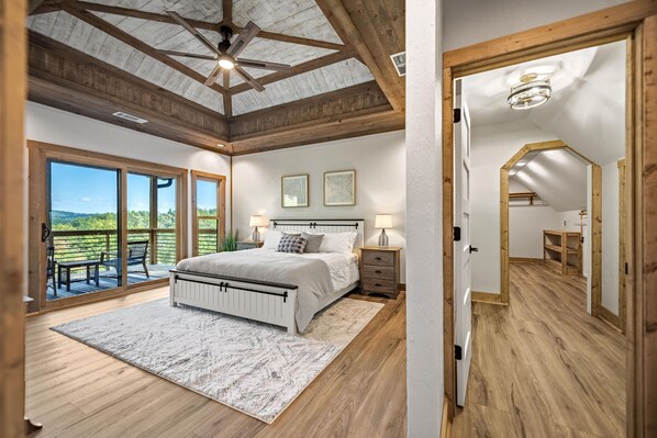 Relax in this serene bedroom with a large bed, bedside tables, and a skylight.