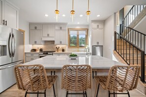 Enjoy cooking in this well-equipped kitchen with a large island, stainless steel appliances, and an oven.