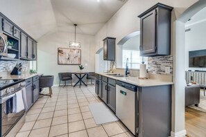 Fridge, dishwasher, coffee/tea maker, cookware/dishes/utensils