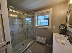 Shower, hair dryer, towels, toilet paper