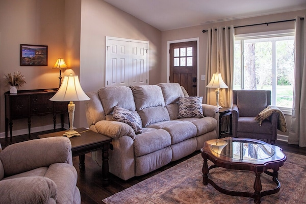 Comfortable living room with electric fireplace and smart tv.
