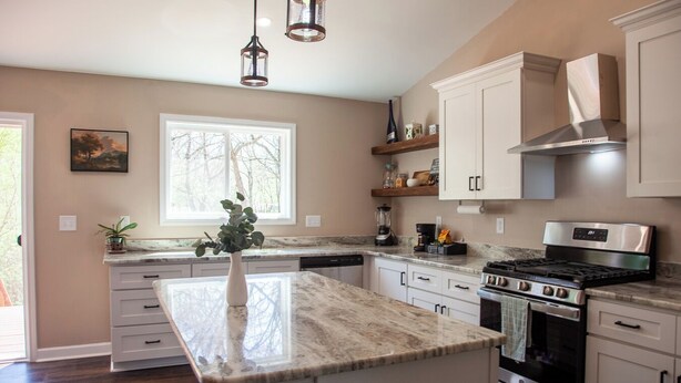 A modern kitchen with a large island, stainless steel appliances, and a window providing natural light. - 3-bedroom house near Deep River, Toyota Megasite, NC Zoo & Zoo Sports Complex (Franklinville)