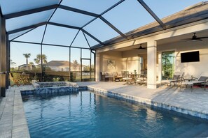A pool area with a glass enclosure, lounge chairs, and a view of the surrounding landscape. - 2-bed, office, 2.5 Bth Home w/ Saltwater Pool, hot tub in WP Golf & Country Club (Englewood)
