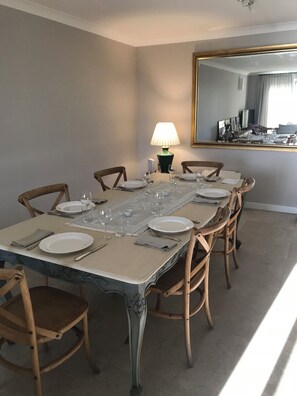 Enjoy meals in this elegant dining room with a long table and six comfortable chairs.
