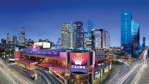 A hotel with a prominent 'Crown' sign, surrounded by a cityscape with modern high-rise buildings. - River View next to Crown | Australia 108 Lux Suite (Southbank)