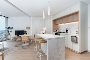 Enjoy cooking in this kitchen with a central island, stove, and ample counter space.