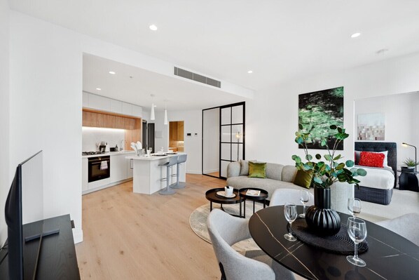 Enjoy a comfortable stay in this apartment with a spacious living area, dining table for two, and a well-equipped kitchen.