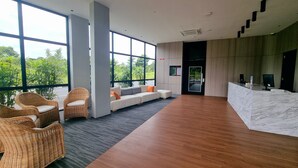 A spacious lobby with large windows, a reception desk, and seating area. - ROXY HOTEL MALIHAH (Kuching)