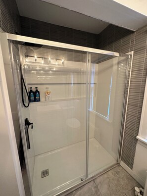 Shower, hair dryer, towels, toilet paper