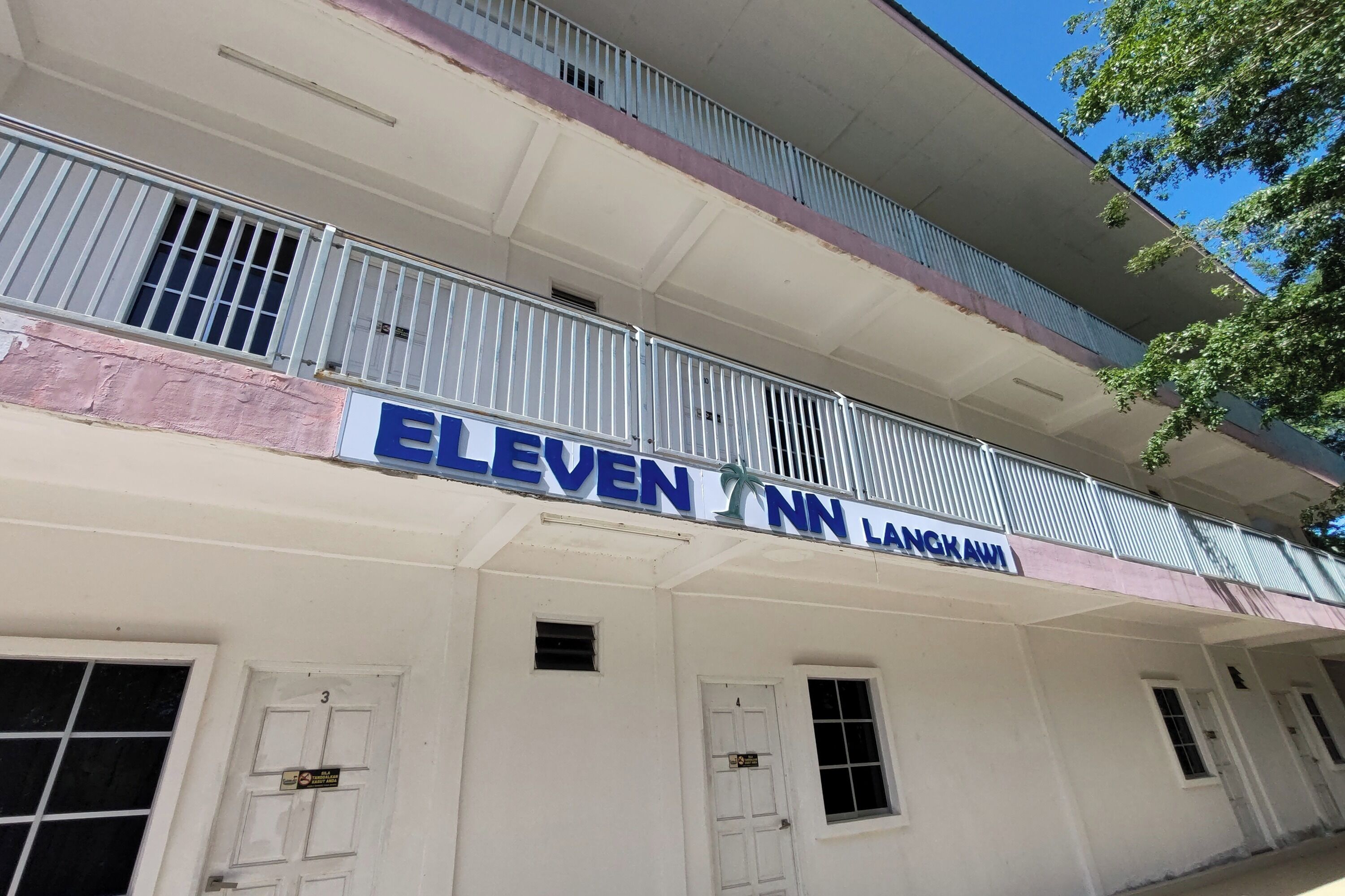 A building with a sign reading "ELEVEN NN LANKAWI".