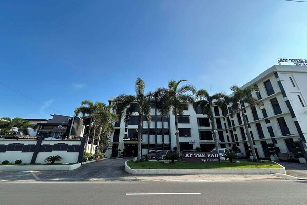 A multi-story hotel with a sign reading 'AT THE PAD' and 'By: TITANS'. - At The Pad Hotel and Resort near Clark Airport (Angeles City)