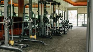 A gym with various exercise equipment, including weight machines and free weights.