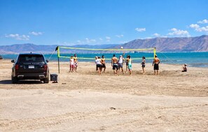 A beach volleyball game with a Range Rover parked nearby. - Timberhaven - Bear Lake Retreat - Sleeps 50+ (Fish Haven)