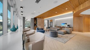 A modern living room with a sofa set, a coffee table, and a TV.