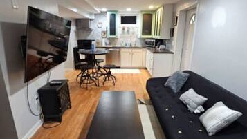 Relax in this stylish space with a flat-screen TV, comfortable sofa, and dining area.