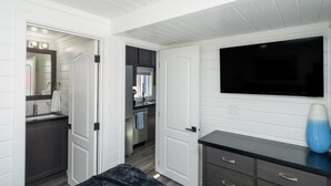 A modern bathroom with a vanity, mirror, and sink.