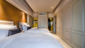 A hotel room with a large bed, a wardrobe, and a bathroom visible through an open door.