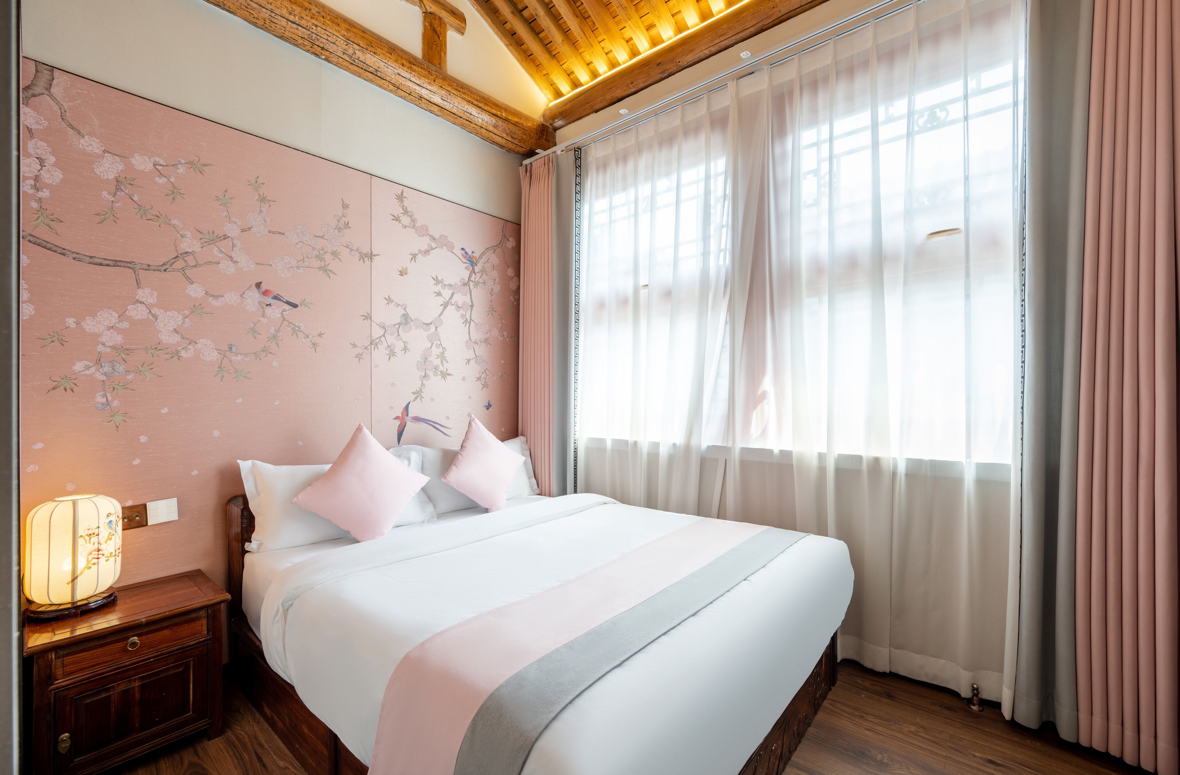 A bedroom with a bed, nightstand, and wall art.