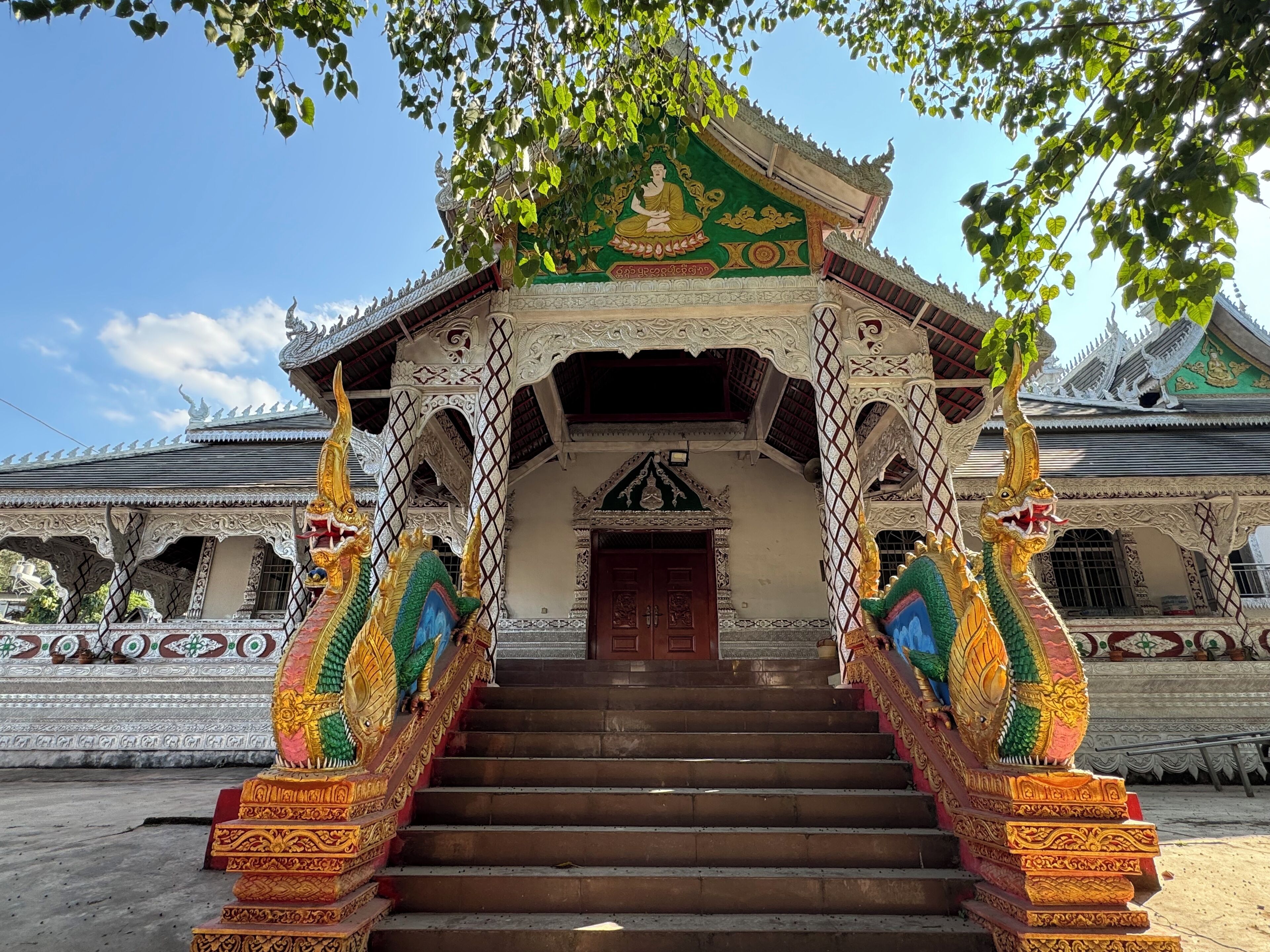 A temple with ornate architecture, a central doorway, and a staircase leading up to it.